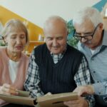 Older adults talking together over a photo album