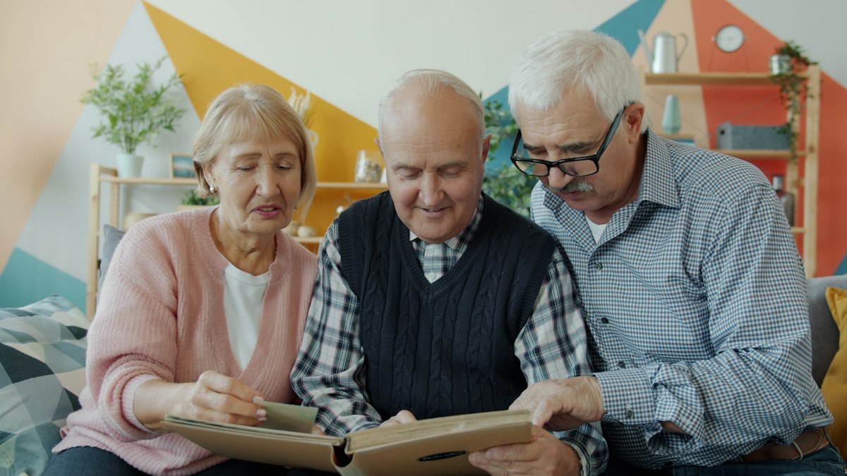 Older adults talking together over a photo album